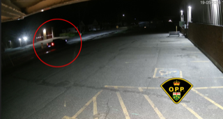 Parking lot with a vehicle highlighted in a red circle