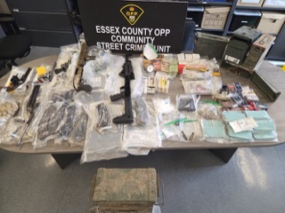 Firearms and drugs seized.