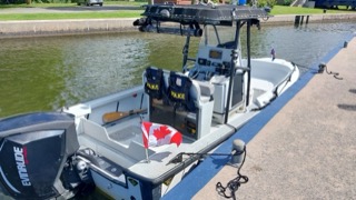 Police boat docked at a pier.