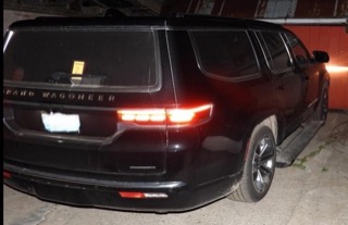 Black Jeep Grand Wagoneer, rear view
