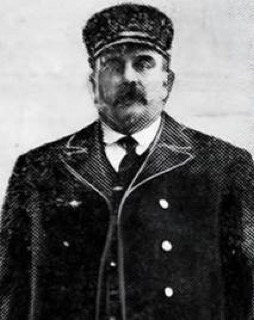 Man in a peaked cap and suit, mustache